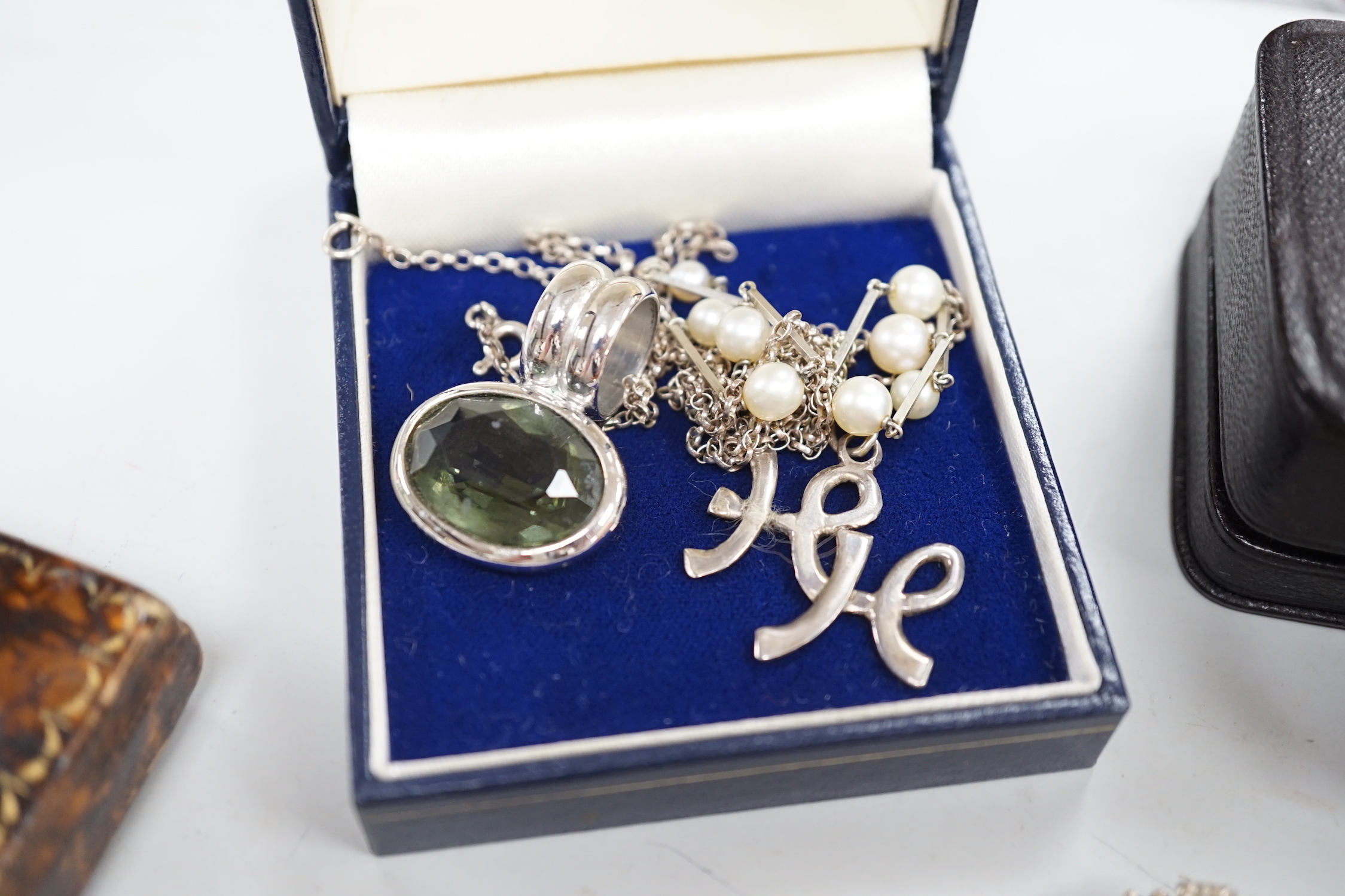 A small collection of costume jewellery, including silver pendants, amber necklace etc, together with a silver napkin ring.
